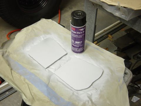 1991 Ford Bronco - Two metal patches are prepared for coating with Weld-Thru II spray, suggesting frame repair or modification work.