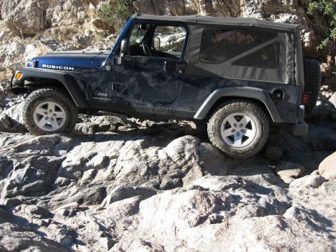2005 Jeep YJ - A 2005 Jeep Wrangler TJ Rubicon navigates a rocky trail.