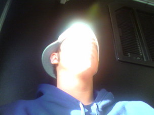 1996 Ford Probe - A person is inside a vehicle, looking upwards towards a bright light source.