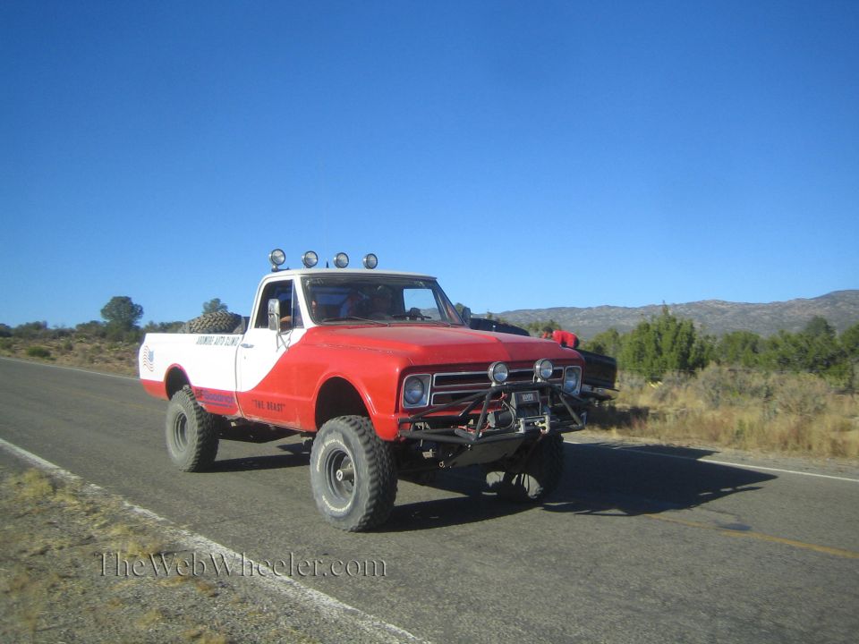 Vintage red and white Chevrolet pickup truck on rural highway