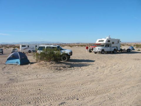 1997 Ford Ranger - Multiple vehicles and tents are set up at a desert campsite on a sunny day.