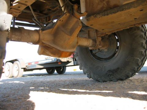 1997 Ford Ranger - Underside view of a truck's rear axle and tire, with a trailer visible behind it.