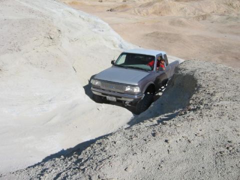 1997 Ford Ranger - A silver 1997 Ford Ranger navigates a steep, sandy incline in a desert landscape.