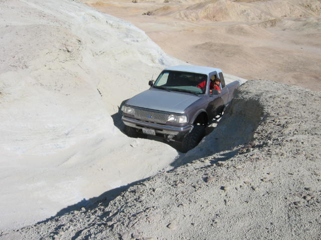 Silver 1997 Ford Ranger driving on a dirt hill
