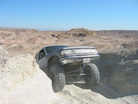 1997 Ford Ranger - Modified 1998 Ford Ranger navigates a steep dirt hill in a desert environment.