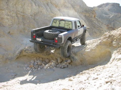 1997 Ford Ranger - This pickup truck is navigating a challenging, rocky terrain with steep inclines.
