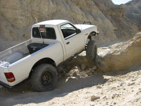 1997 Ford Ranger - A white 1997 Ford Ranger pickup truck is shown off-roading on a rocky trail.
