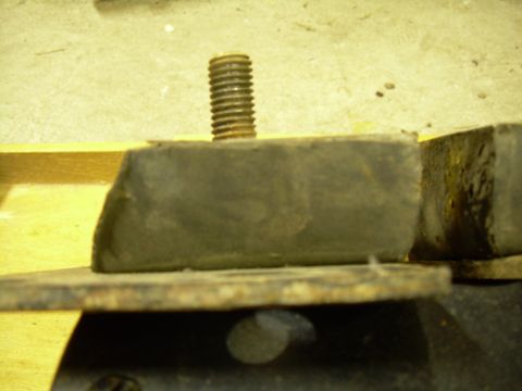 1978 Ford Bronco - A close-up view of a worn motor mount, showing rust and rubber degradation.