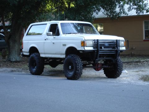 1989 Ford Bronco - This lifted 1989 Ford Bronco features oversized tires and a heavy-duty brush guard, ready for off-road adventures.