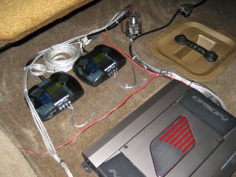 1979 Ford Bronco - Car audio components including an Orion amplifier and two crossovers are installed on the vehicle's carpeted floor.