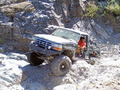 1991 Ford Bronco - This 1991 Ford Bronco is tackling a challenging off-road course on a sunny day.