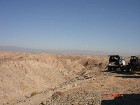 1996 Ford Bronco - Off-road vehicles parked at the edge of a desert canyon.