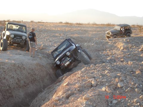 1996 Ford Bronco - Off-road vehicles tackle a challenging terrain with steep inclines and rocky obstacles.