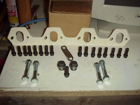 1989 Ford Bronco - A new exhaust manifold gasket and its accompanying hardware are neatly arranged for installation.
