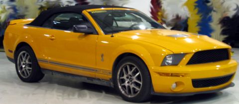 1971 Ford Ranchero - Yellow convertible with black top and side stripes, 'GT 500' badging.