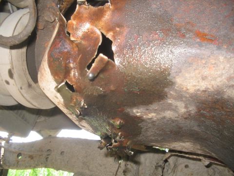 1990 Ford Bronco - Undercarriage part showing severe rust damage and structural compromise.