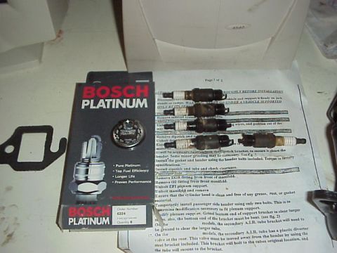 1989 Ford Bronco - Bosch Platinum spark plugs are shown with their packaging and installation guide.