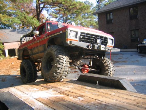 1979 Ford Bronco - This heavily modified Ford truck features oversized tires and a lifted suspension, suggesting off-road capabilities.
