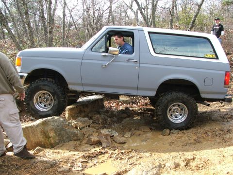 1996 Ford Bronco - This 1996 Ford Bronco is shown off-roading over rocks and mud.
