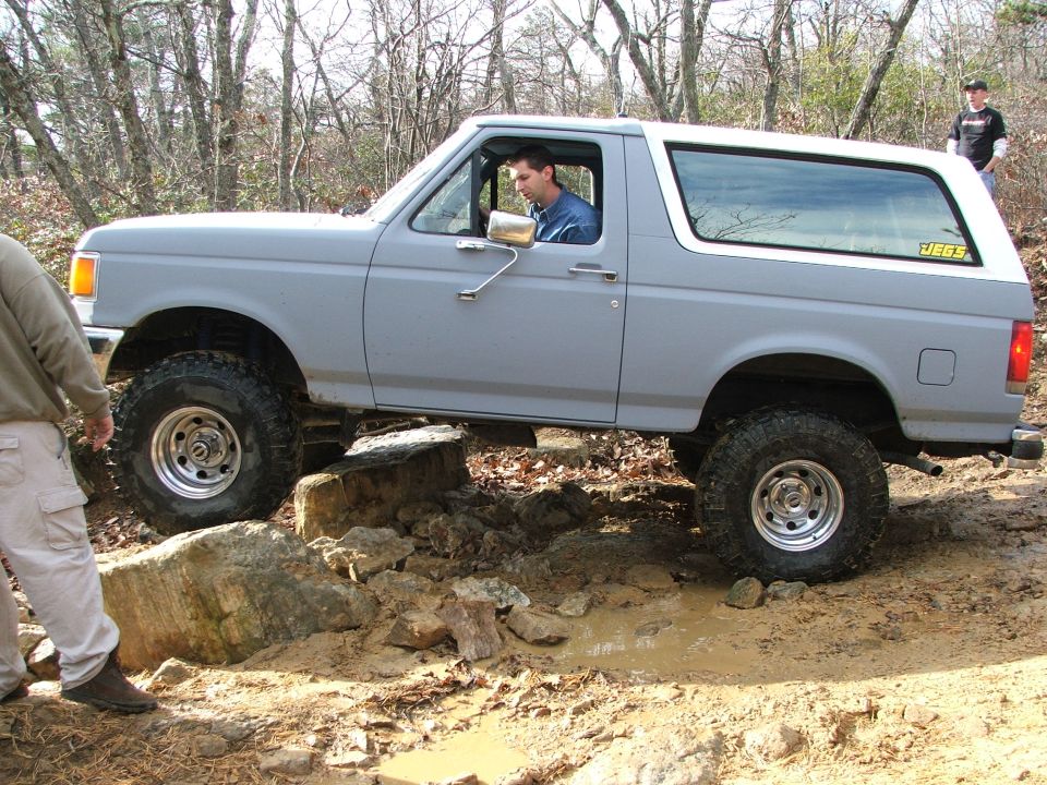 Gray 1996 Ford Bronco navigating rocky terrain