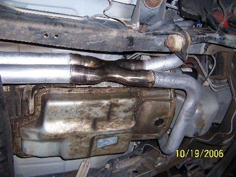 1991 Ford Bronco - Close-up view of a custom exhaust Y-pipe and transmission pan, dated 10/19/2006.