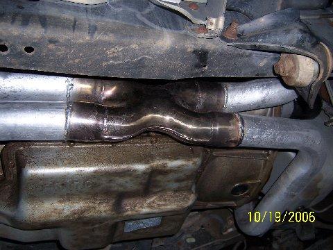 1991 Ford Bronco - A close-up view of a custom exhaust system, showing a Y-pipe and muffler assembly.