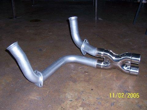 1991 Ford Bronco - A metal exhaust y-pipe with two outlets is shown on a concrete floor, dated 11/02/2006.