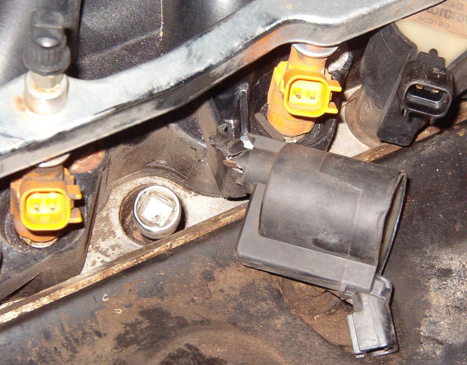 The coil was damaged by the spark plug hammering it for ~15 miles, but I broke a little more away so it would fit on top of the extension.