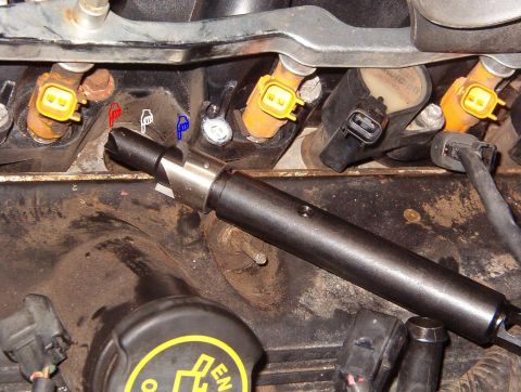 1999 Ford Crown Victoria - The first tool starts by cleaning out any remaining spark plug threads (red pointer), then uses a smooth pilot (white) to hold the cutter (…