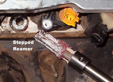 1999 Ford Crown Victoria - Next, the reamer is used to enlarge the hole for the tap. More grease catches most of the shavings.