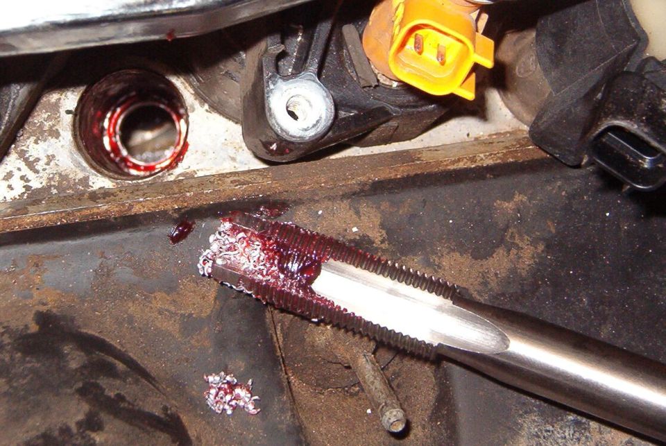 The tap also has a pilot tip, and the instructions recommend grease again.  I used a manual ratchet to drive the tap, but the air ratchet to remove it.

This is the time to vacuum out the cylinder to remove any shavings & grease.   I used a ShopVac micro tool kit, then a borescope to inspect.  After wiping the hole with clean rags to remove the bulk of the grease, I rinsed it briefly with brake cleaner & then cranked the engine for a moment to blow any residue or remaining debris out.