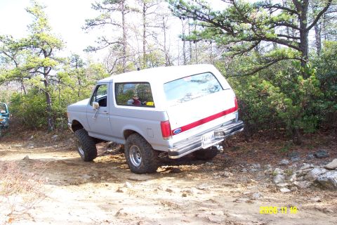 1987 Ford Bronco - This 1987 Ford Bronco is shown flexing its suspension while navigating an off-road trail.