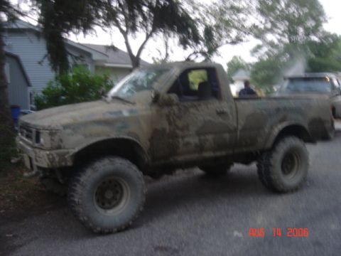 1992 Toyota Tacoma - This 1992 Toyota Tacoma is covered in mud, showing its off-road capabilities.