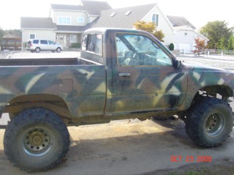 1992 Toyota Tacoma - This 1992 Toyota Tacoma pickup truck features a distinctive camouflage paint job and an elevated suspension system.