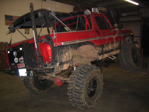1979 Ford Bronco - This heavily modified red Ford Bronco features a lifted suspension and oversized off-road tires.