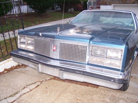 1999 Ford Crown Victoria - This Oldsmobile Delta 88 features a distinctive chrome grille and dual rectangular headlights.
