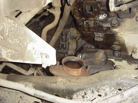 1989 Ford Bronco - Engine component with a spark plug and exhaust connection visible.