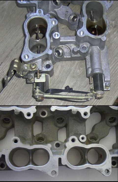 1997 Ford Taurus - Close-up of an intake manifold, showing internal ports and linkage mechanism.