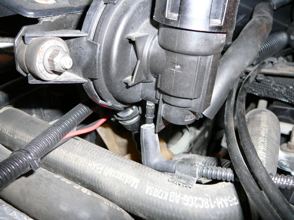 Engine bay close-up with DPFE sensor removed and vacuum lines hanging