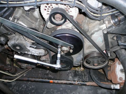 1997 Mercury Grand Marquis - Step 4: Using the pulley wrench, loosen 2 of the 10mm bolts holding the pulley to the water pump(DO NOT REMOVE). then rotate the pulley wre…