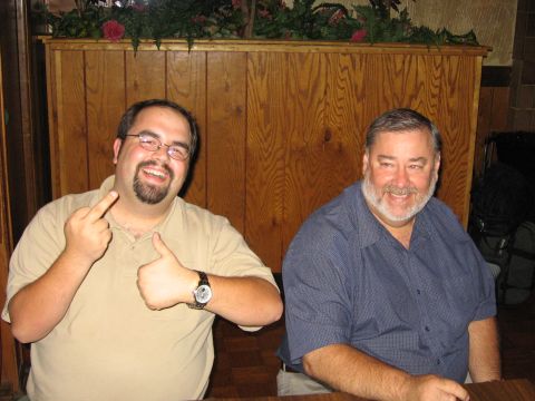 2003 Ford Focus - Two men pose for a photo, one making gestures while the other smiles.