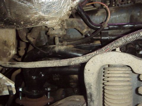 1989 Ford Bronco - Close-up view of engine components, including an exhaust manifold and wiring, with Supermotors.net watermark visible.