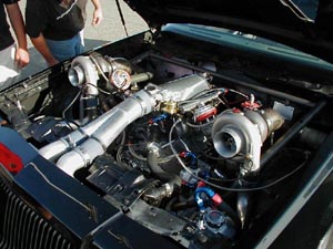 1991 Ford Taurus - Custom twin-turbo V8 engine bay with prominent turbos and intercooler piping.