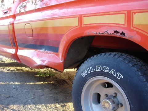1979 Ford F-150 - here is the damage-dad ran over the spare tire in the dark.