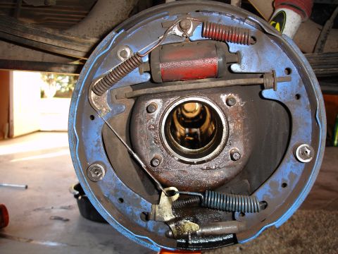 1979 Ford F-150 - The internal components of a vehicle's drum brake system are shown, including the brake cylinder and springs.