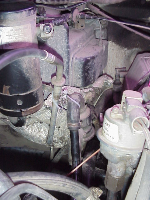 1989 Ford Bronco - Detail of engine components, including hoses and a label reading A33.