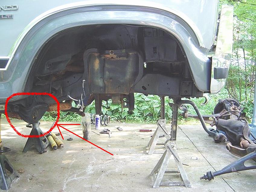1986 Ford Bronco rear axle and suspension removed and supported by jack stands