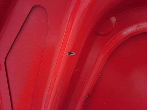 2005 Dodge SRT-4 - Close-up of a red car's interior shows minor paint damage and a website watermark.