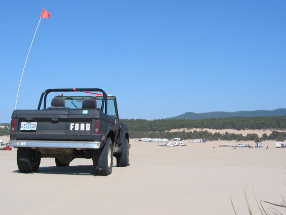 1968 Ford Bronco rear view on sand dunes with orange flag
