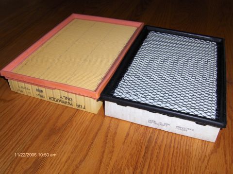 2004 Ford Crown Victoria - Two air filters are displayed on a wooden surface. One filter is labeled for a Marauder, suggesting it is a specific part.